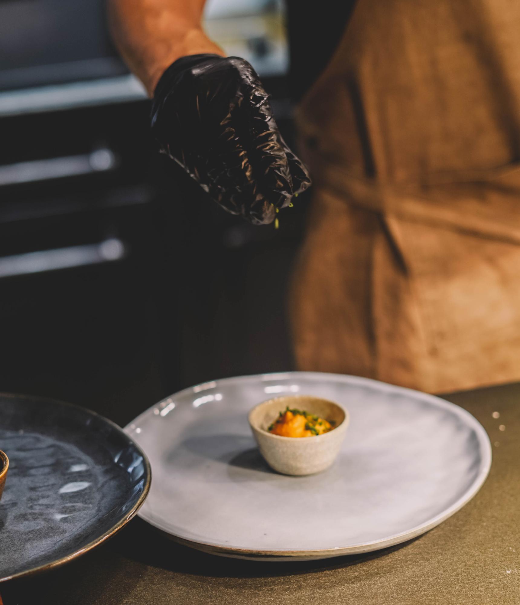 Chef hands plating a dish